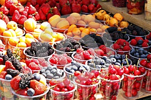 assorted fresh berries (berry) fruits in a street stall for sell