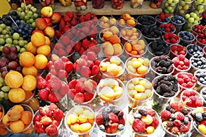 assorted fresh berries (berry) fruits in a street stall for sell