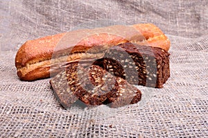 Assorted fresh breads isolated on old sackcloth.