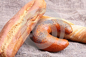 Assorted fresh breads isolated on old sackcloth.