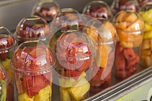 Assorted fresh fruit salad in plastic cups