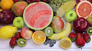 Assorted fresh fruits for healthy eating on white wooden table