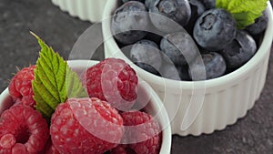 Assorted fresh summer fruits in small cups on the table