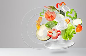 Assorted fresh vegetables flying in a plate