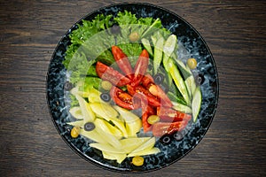 assorted fresh vegetables, tomato, cucumber, pepper, lettuce, olives