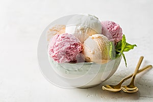 Assorted fruit and berries ice cream in a bowl, lemon, strawberry and peach flavours