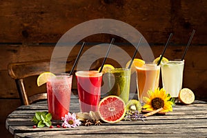 Assorted fruit smoothies on wooden background