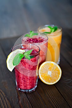 Assorted fruit smoothies on a wooden table