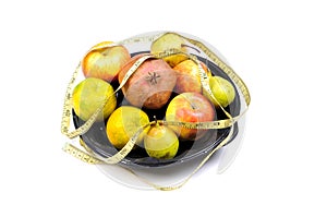 Assorted fruits with measuring tape