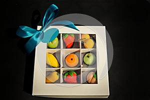 Assorted fruits shaped candy made from sugar marzipan in white gift box