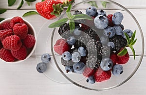 Mixed berries in glass bowls closeup, top view