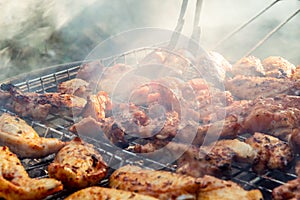 Assorted grilled chicken meats on the flaming grill