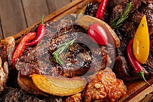 Assorted grilled meat set on wooden serving board