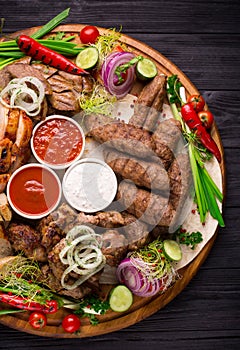 Assorted grilled meat and vegetables on rustic table