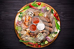 Assorted grilled meat and vegetables on rustic table