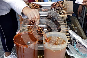 Assorted grilled pork innards such as intestine, liver, gizzard and blood in barbecue sticks