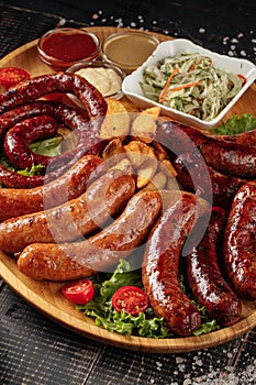 Assorted grilled sausages set on wooden board