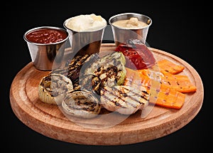 Assorted grilled vegetables on a wooden board