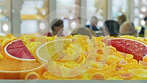 Assorted gummy candies and candy jellies on showcase of candy store background. Closeup of colorful jelly sweets