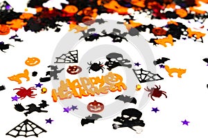 Assorted halloween confetti., jack-o-lantern, skeletons, skulls, spiders, bats