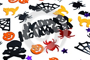 Assorted halloween confetti., jack-o-lantern, skeletons, skulls, spiders, bats