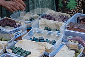 Assorted handmade chocolates at a market stall.