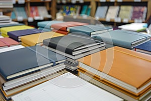 Assorted Hardcover and Paperback Books Spread Out on Table in Library for Education Background