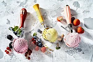 Assorted ice cream flavours in metal scoops