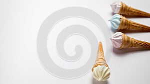 Assorted ice cream in sugar cones isolated on white background