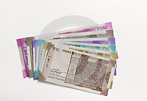 Assorted Indian rupee currency notes on white background.