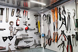 Assorted instruments for car maintenance on wall