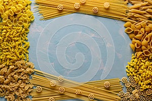 Assorted Italian pasta: Penne rigate, Rotelle, Conchiglie, Cavatappu, Fusilli, Cellentani, Spaghetti, horizontal