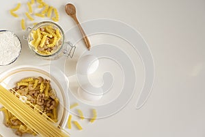 Assorted Italian pasta. On a white background. View from above. Pasta on a plate. Flour, eggs and pasta made from them