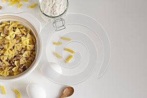 Assorted Italian pasta. On a white background. View from above. Pasta on a plate. Flour, eggs and pasta made from them