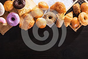 Assorted junk food multiple type on black wooden table of top view with copy space