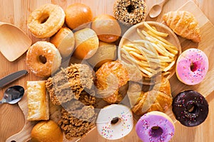Assorted junk food multiple type on wooden table of top view
