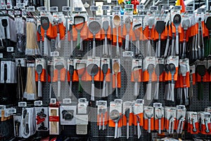 Assorted kitchen utensils and cooking tools on display rack in store.
