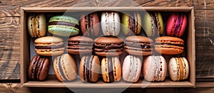 Assorted macarons in a box on rustic wood