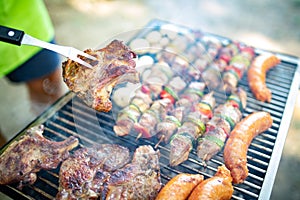 Assorted meat from chicken, pork and various vegetables on barbecue grill