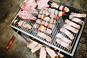 Assorted meat from chicken, pork and various vegetables on barbecue grill