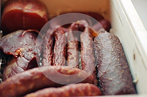 Assorted meat products including ham and sausages.