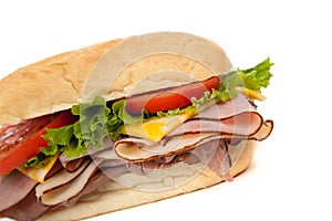 Assorted meat sandwich with fixings on a hoagie photo