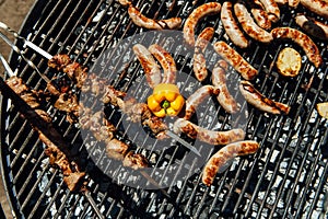 Assorted meat and vegetables grilling over fire