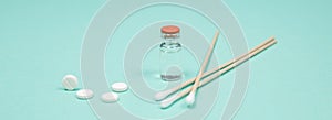 Assorted medical drugs and syringe on blue background