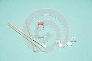 Assorted medical drugs and syringe on blue background