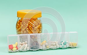 Assorted medical drugs and syringe on blue background