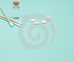 Assorted medical drugs and syringe on blue background