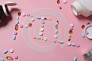 Assorted medicine pills on pink background. Top view