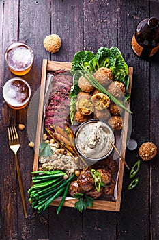 Assorted middle eastern dishes: falafel, meat, potato, cauliflower and babaghanoush