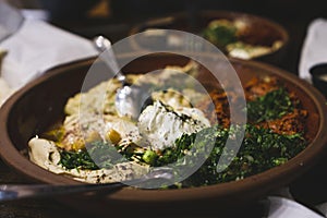 Assorted Middle Eastern dishes including hummus, baba ghanoush, tabbouleh, salad. Oriental appetizer on rusty plates